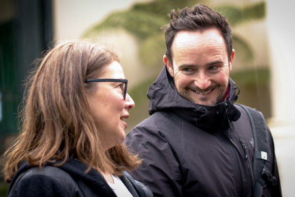 Pat chatting to a woman while walking outdoors